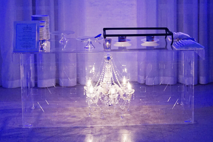 chandelier beneath clear lucite table