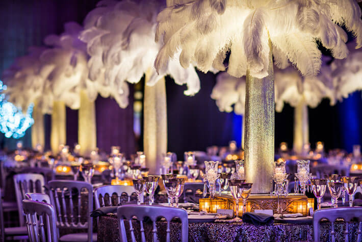 illuminated white feather centerpieces at luxury holiday party 